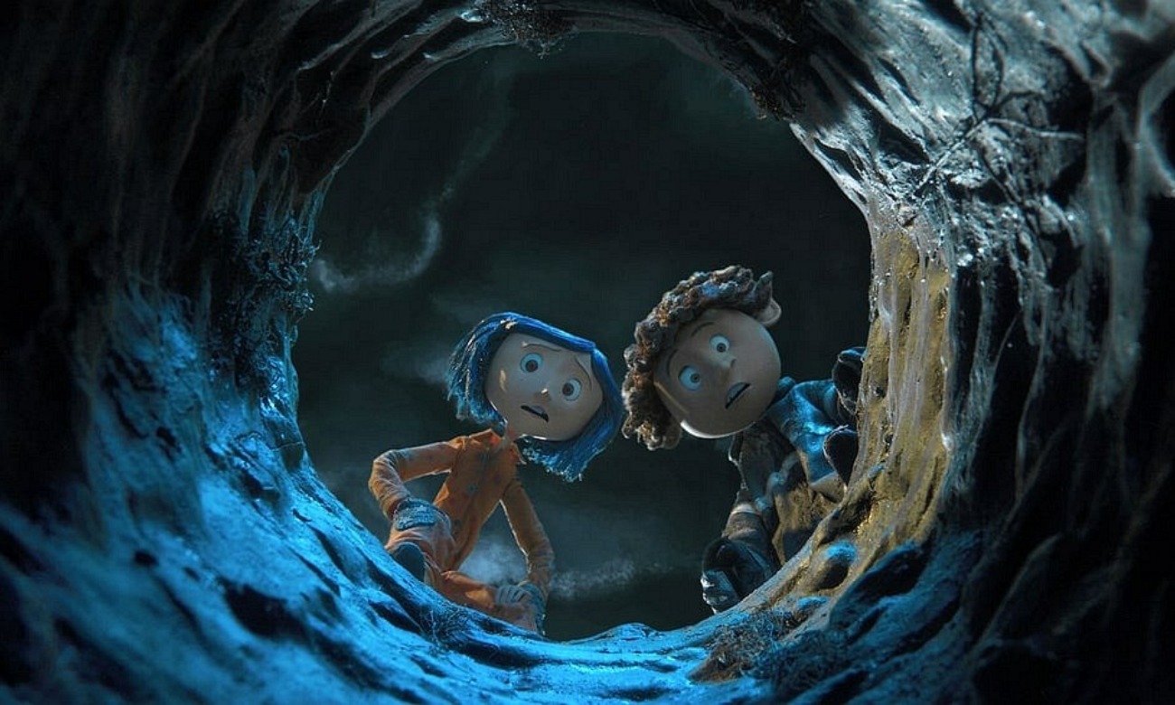 Two animated characters from the movie look down a well in the ground.