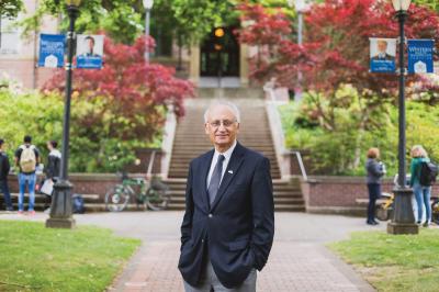 WWU President Sabah Randhawa stands in front of the main stairwell to Old Main
