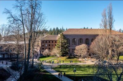 an overhead view of a busy day on campus with students walking to and from classes under blue skies on a winter day.
